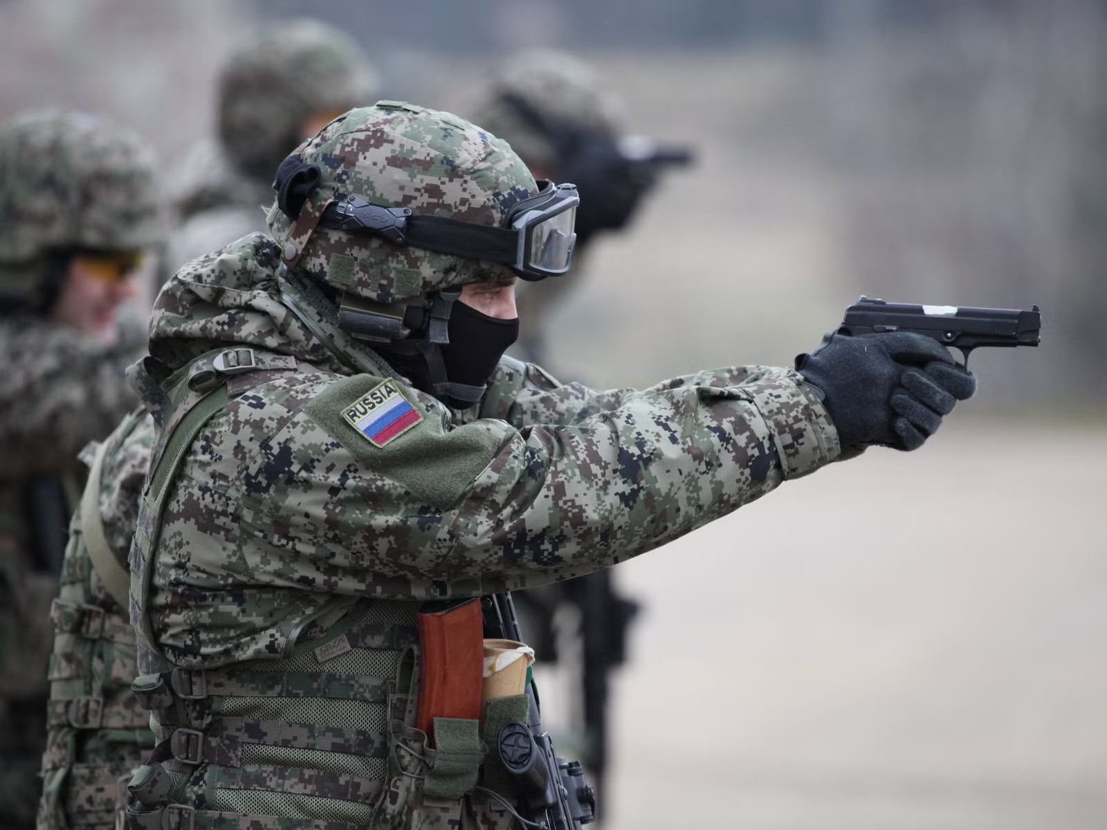 Personnel on a controlled training range practising measured, deliberate marksmanship under instruction.
