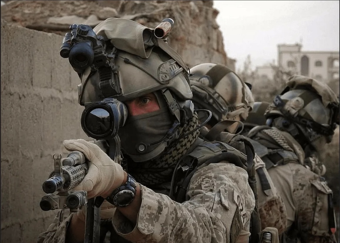 A prepared security team moving in a considered, coordinated sequence along a protected approach.