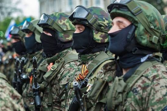 Personnel standing in close formation in protective equipment, illustrating collective discipline and uniform standards.